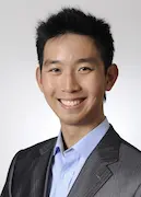 Portrait of leoker's founder in a professional suit, smiling confidently, representing visionary leadership and expertise in global trade and supply chain management